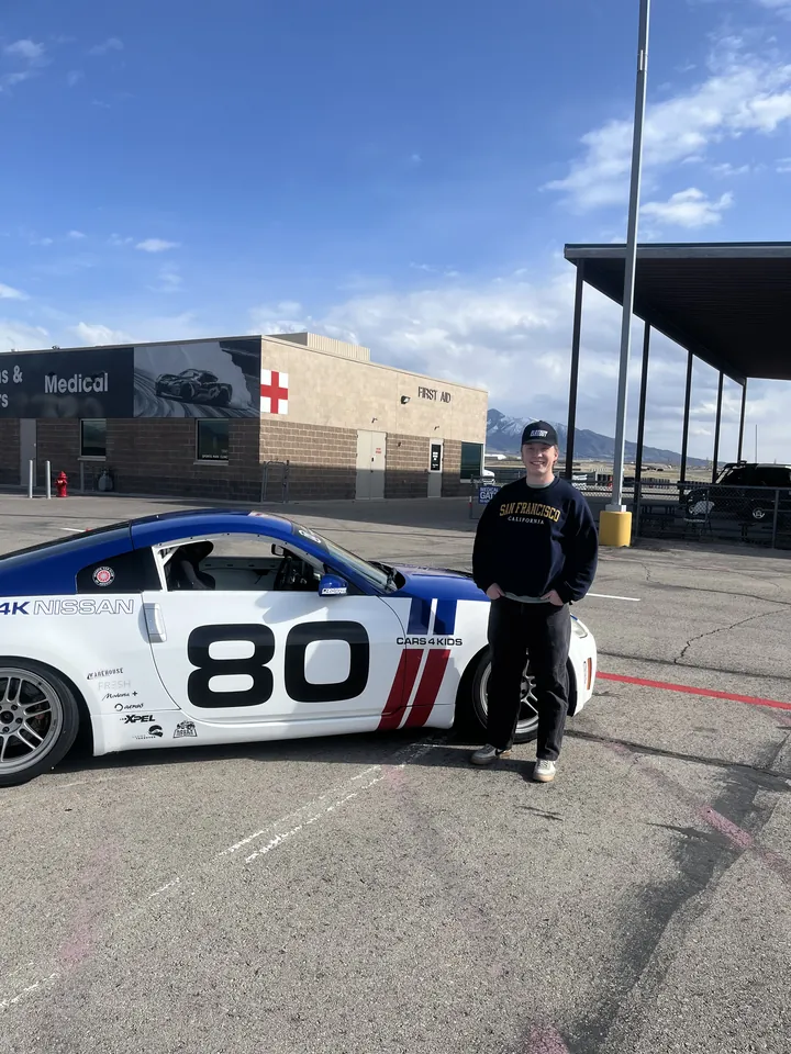 Conner beside the number 80 race car.